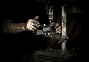 man working on a drill press